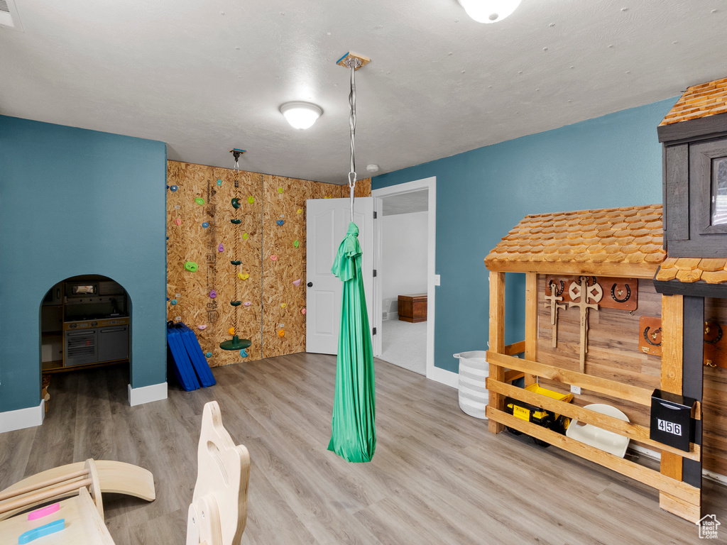 Game room with baseboards and wood finished floors