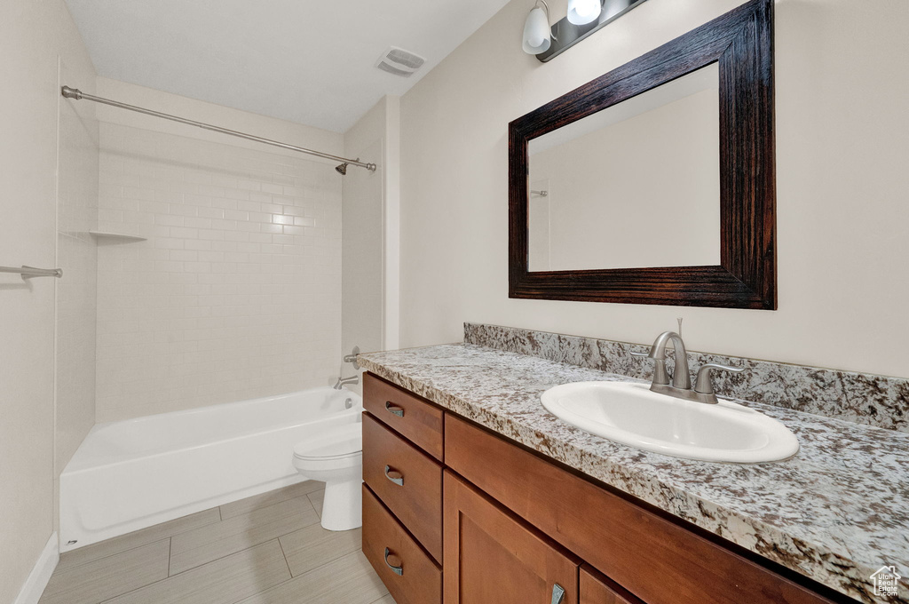 Full bathroom with vanity, washtub / shower combination, and toilet