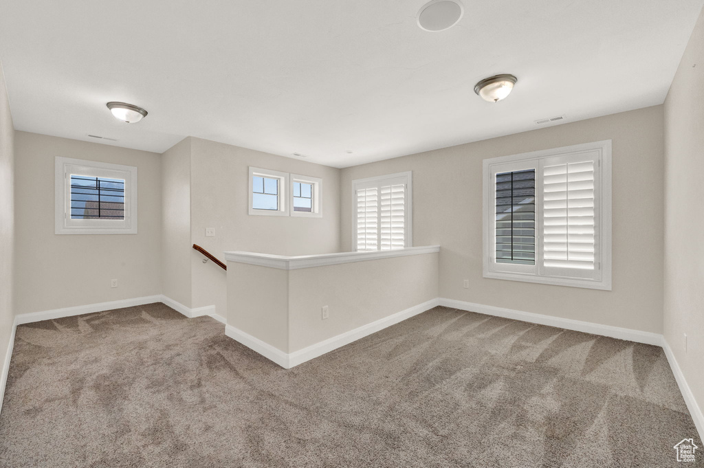 Empty room with carpet and baseboards