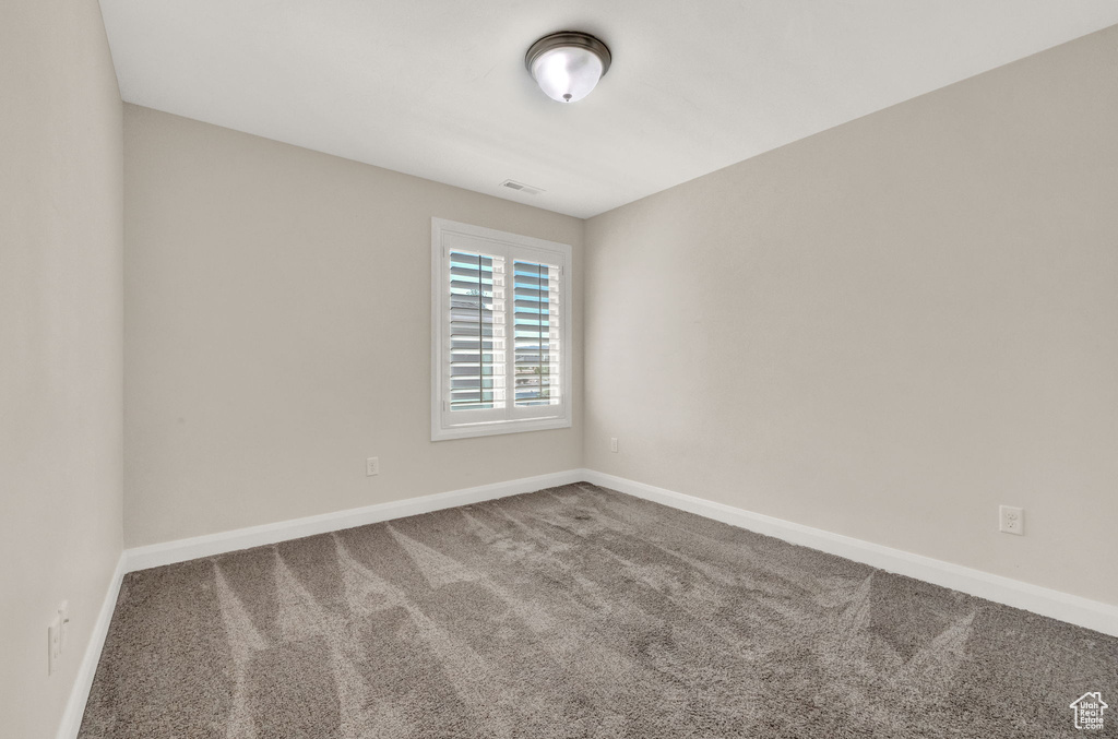 Unfurnished room with carpet flooring and baseboards