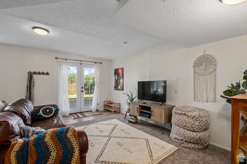 Living room featuring a textured ceiling and french doors