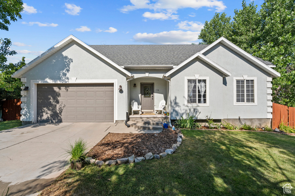 Ranch-style house with an attached garage, driveway, stucco siding, and a shingled roof