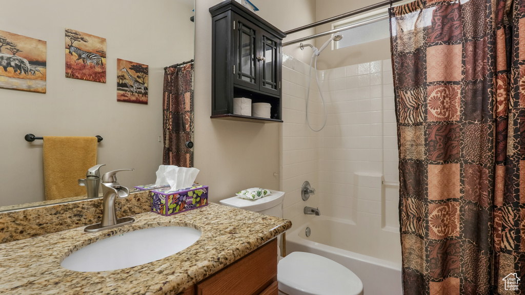 Full bath with vanity, shower / bathtub combination with curtain, and toilet