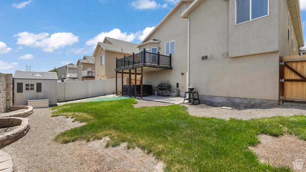 Back of house with a patio area, stucco siding, a residential view, and a balcony