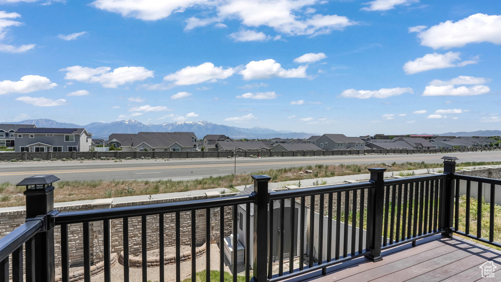 Wooden terrace with a residential view and a mountain view