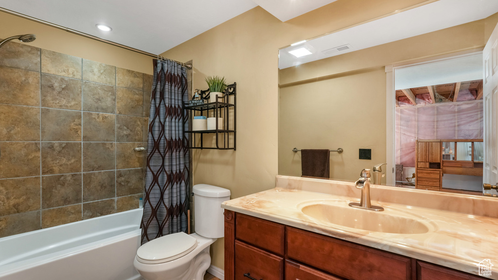 Full bath with shower / tub combo, vanity, and toilet