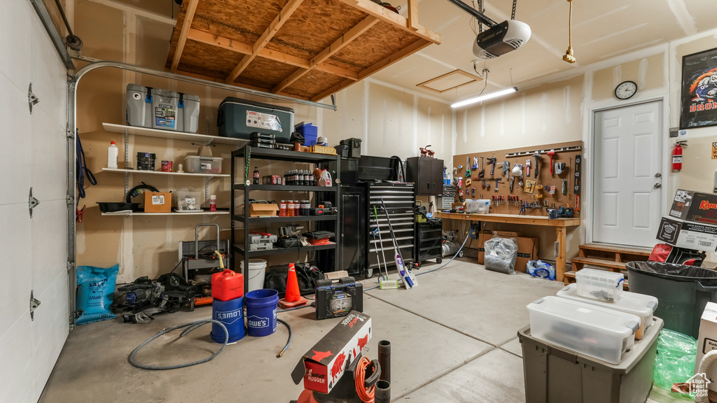 Garage with a garage door opener and a workshop area