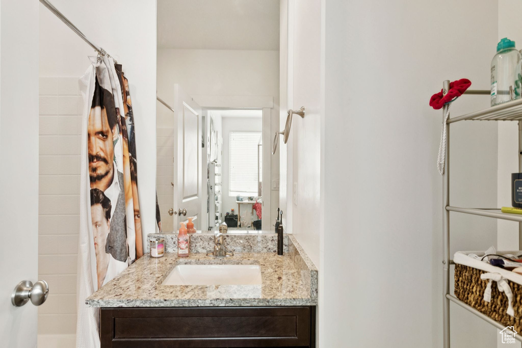 Bathroom featuring vanity and shower / tub combo