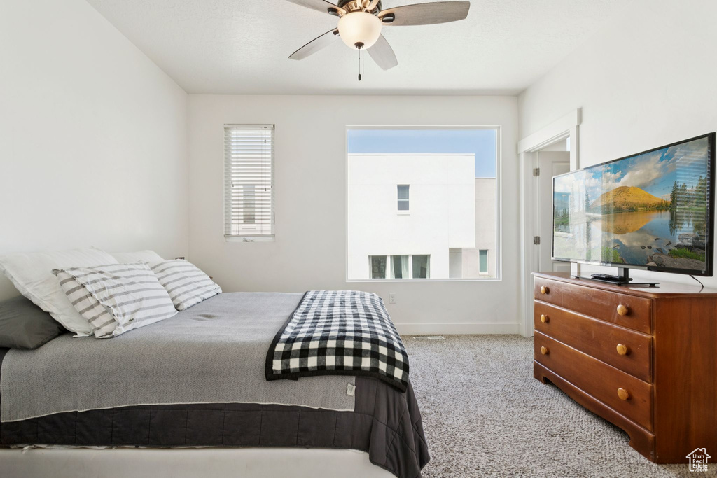 Carpeted bedroom with baseboards and ceiling fan