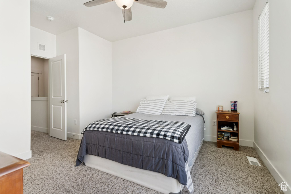 Carpeted bedroom with baseboards and ceiling fan