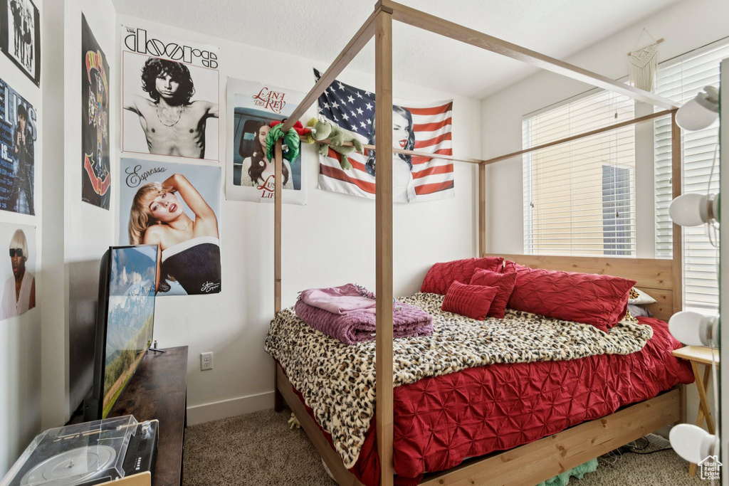 Carpeted bedroom featuring baseboards