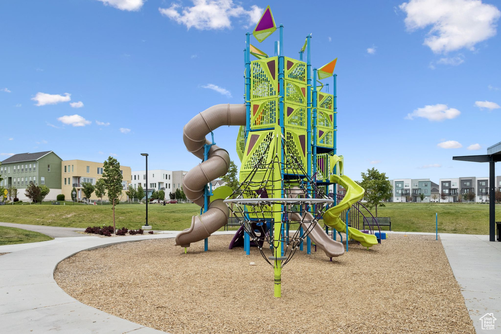 Communal playground with a yard and a residential view