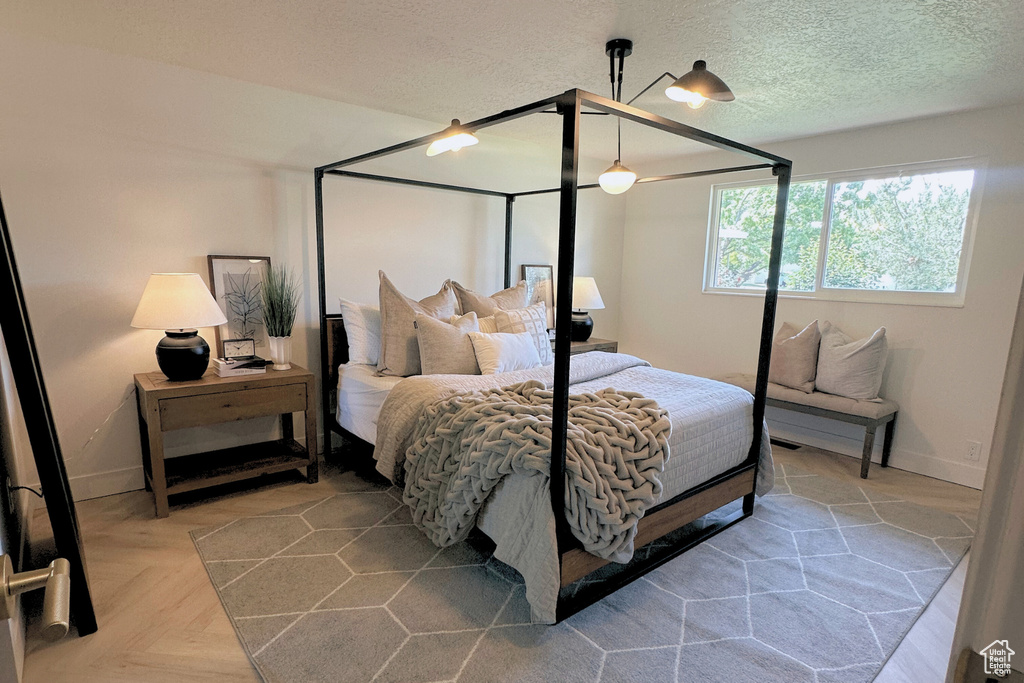 Bedroom with baseboards, a textured ceiling, and ceiling fan