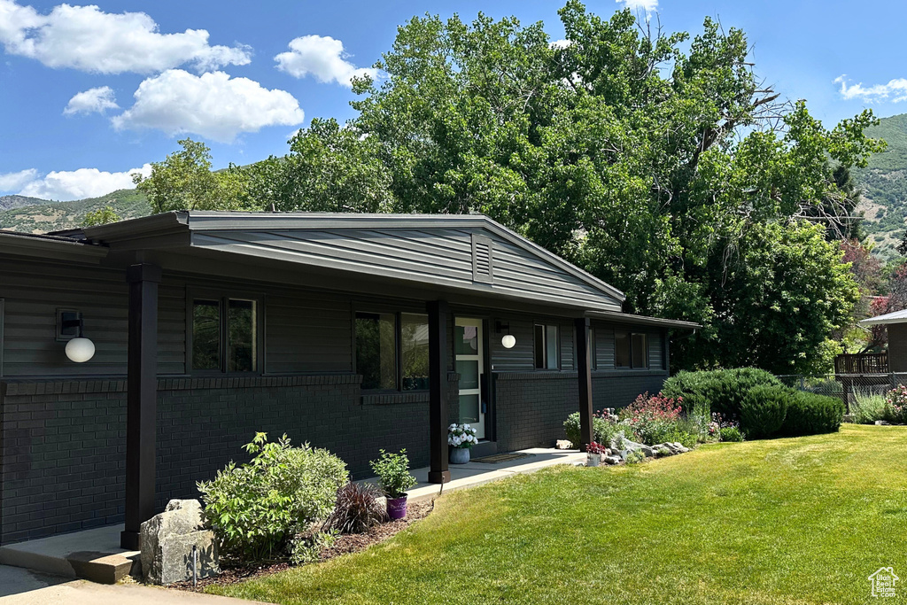 View of front facade featuring a front lawn and brick siding