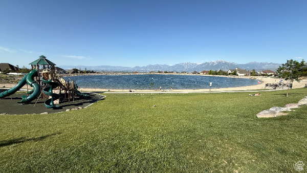 Community jungle gym featuring a lawn and a water and mountain view