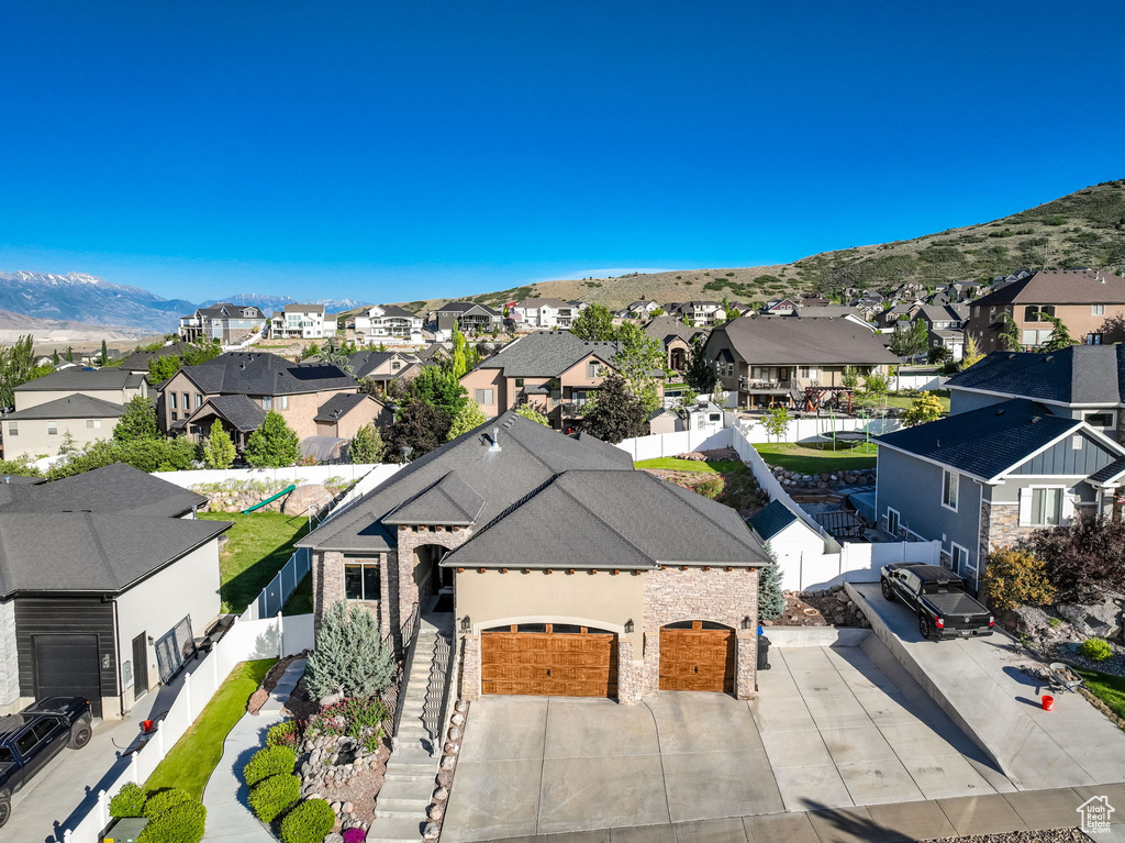 Aerial perspective of suburban area featuring a mountainous background