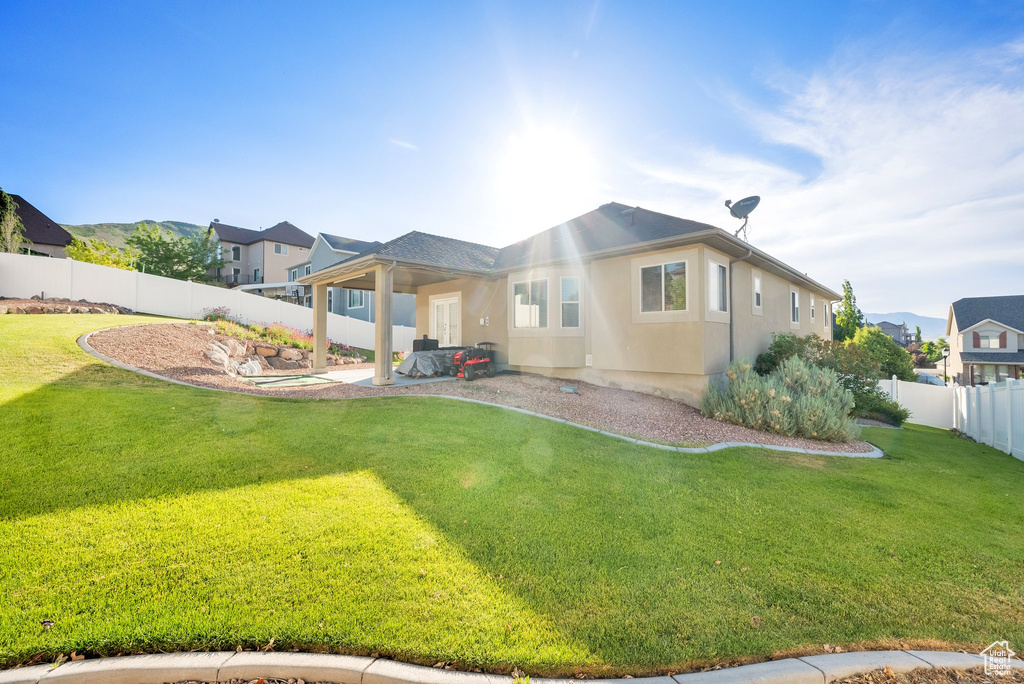 Back of property featuring stucco siding and a patio