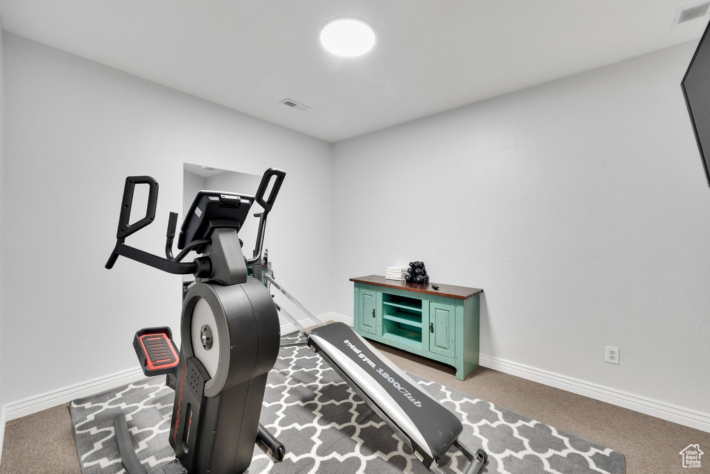 Workout area featuring carpet flooring and baseboards