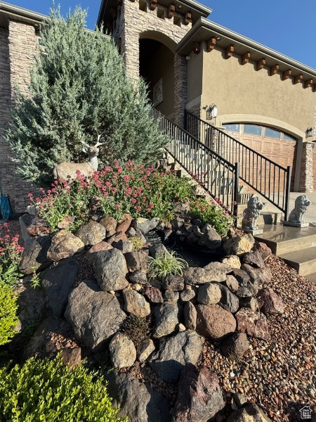 View of property exterior featuring stucco siding and stone siding