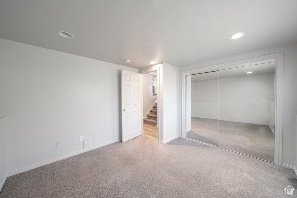 Unfurnished bedroom featuring carpet flooring, recessed lighting, a closet, and baseboards