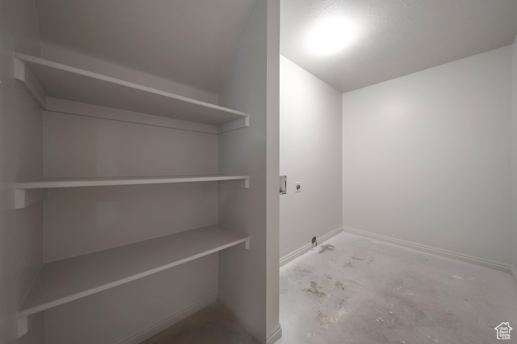 Laundry room with hookup for an electric dryer, baseboards, and hookup for a washing machine