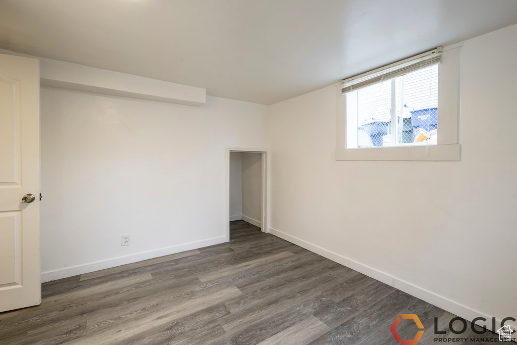 Unfurnished bedroom with baseboards and wood finished floors