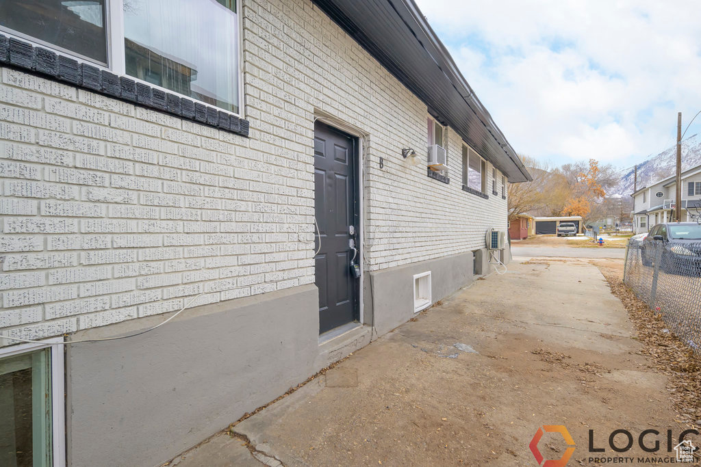 View of property exterior with brick siding