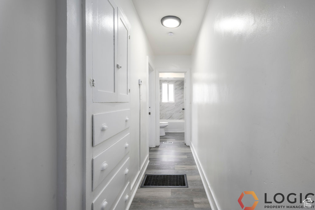 Hallway featuring baseboards and wood finished floors