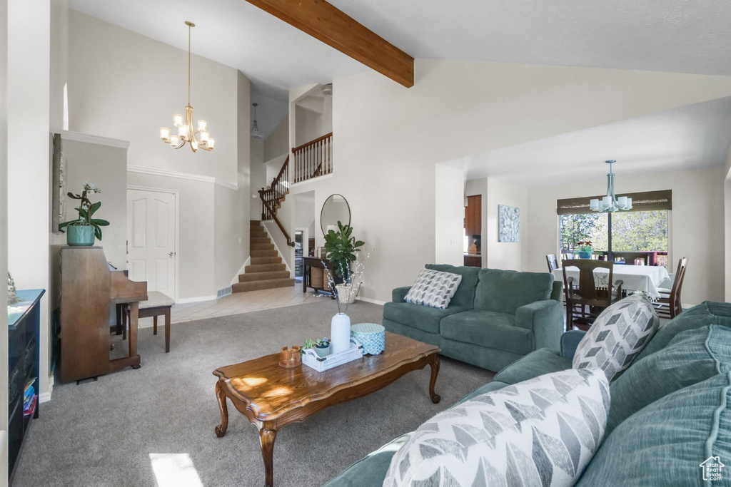 Living area featuring a chandelier, carpet floors, stairway, high vaulted ceiling, and beam ceiling