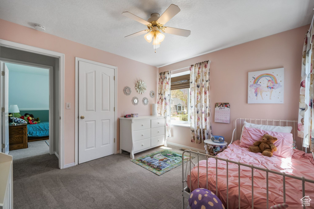 Bedroom with carpet, baseboards, and ceiling fan