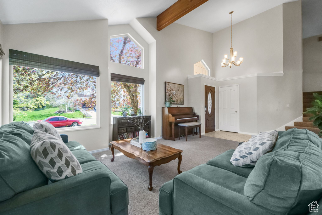 Living area featuring high vaulted ceiling, baseboards, a chandelier, carpet flooring, and beamed ceiling