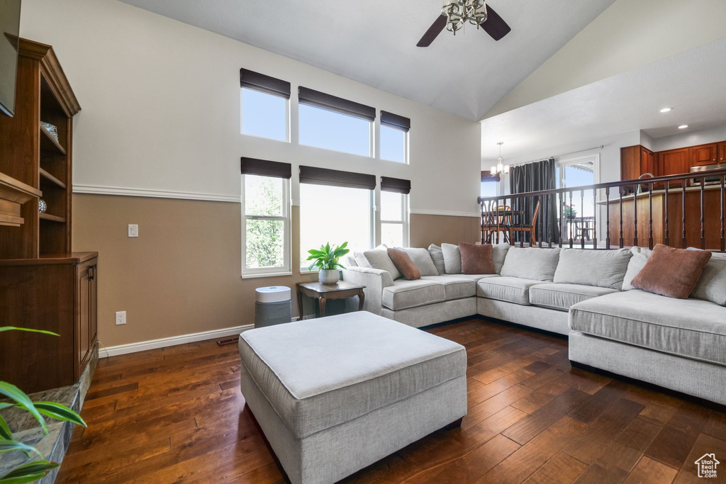 Living room featuring ceiling fan, a chandelier, dark wood-style floors, high vaulted ceiling, and recessed lighting