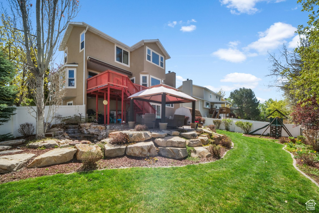 Back of property with stucco siding and a gazebo