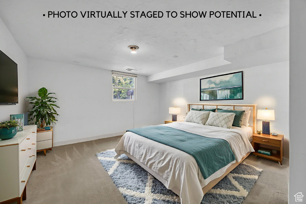 Bedroom featuring light colored carpet and baseboards