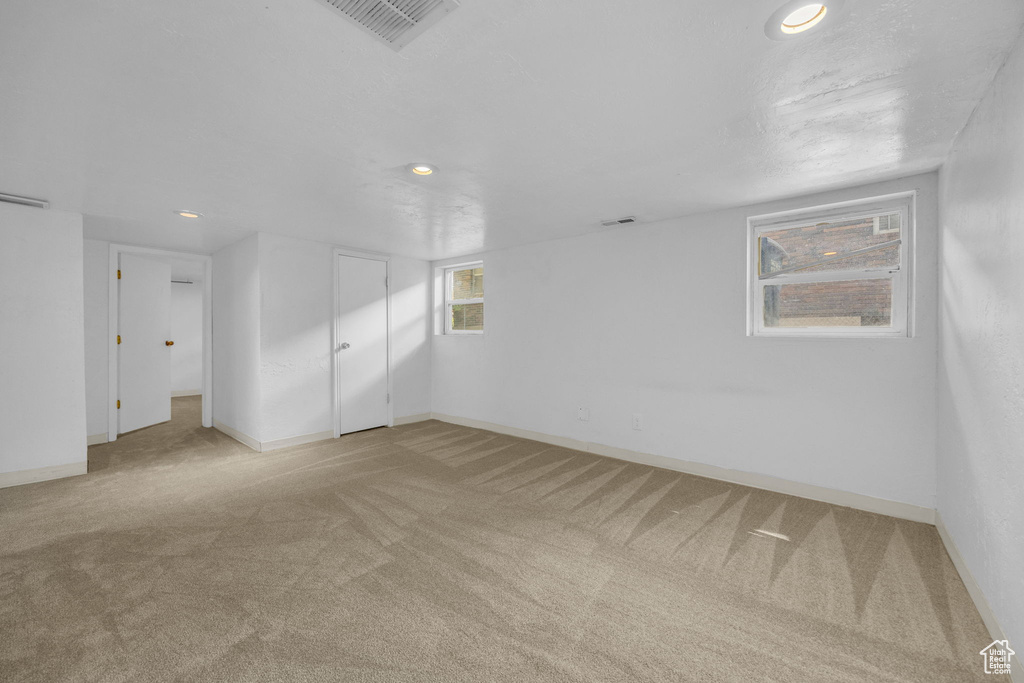 Carpeted empty room featuring recessed lighting and baseboards