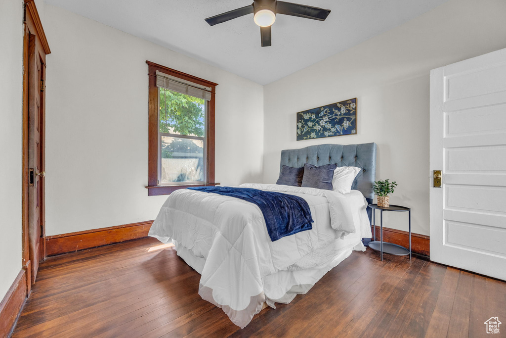Bedroom featuring baseboards, wood-type flooring, and a ceiling fan