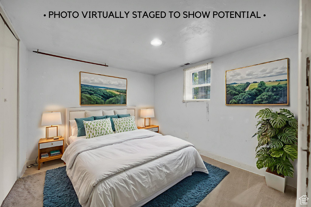 Bedroom featuring light colored carpet and baseboards