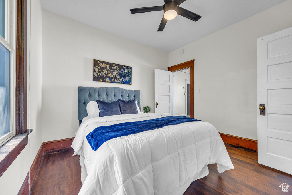 Bedroom with wood finished floors, baseboards, and ceiling fan