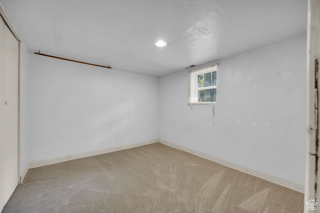 Basement featuring carpet floors and baseboards