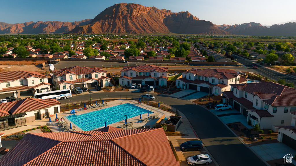 Aerial perspective of suburban area featuring a pool area and mountains
