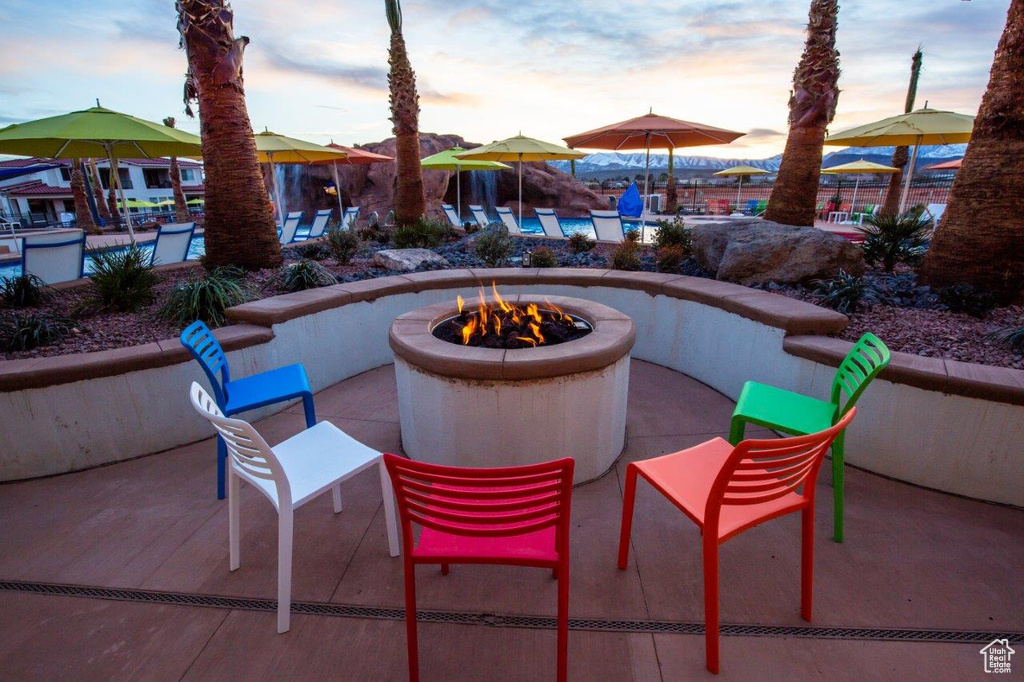 View of patio featuring a fire pit and a pool