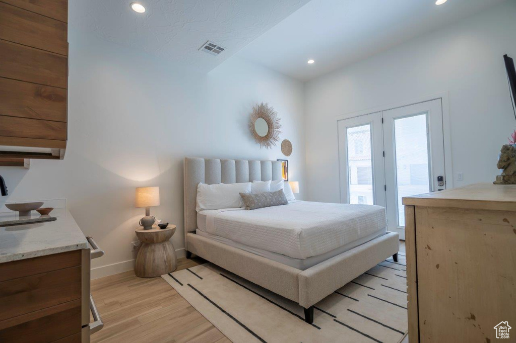 Bedroom with access to outside, light wood-style flooring, recessed lighting, and baseboards