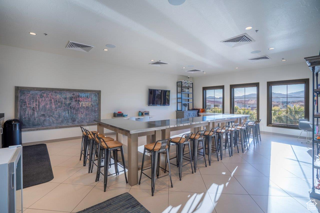 Kitchen with recessed lighting, light tile patterned floors, baseboards, and light countertops
