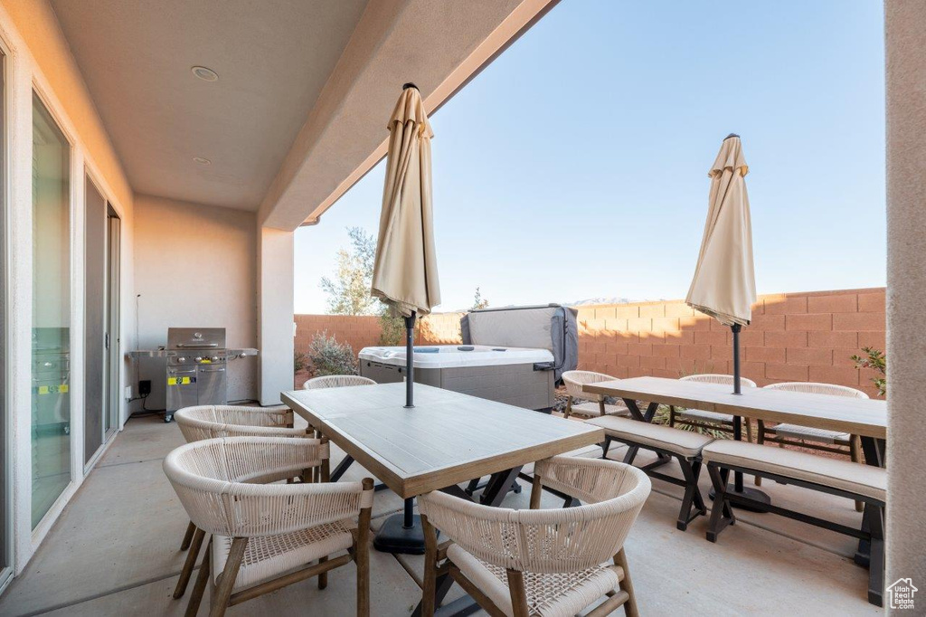 Fenced backyard with outdoor dining area, area for grilling, a hot tub, and a patio