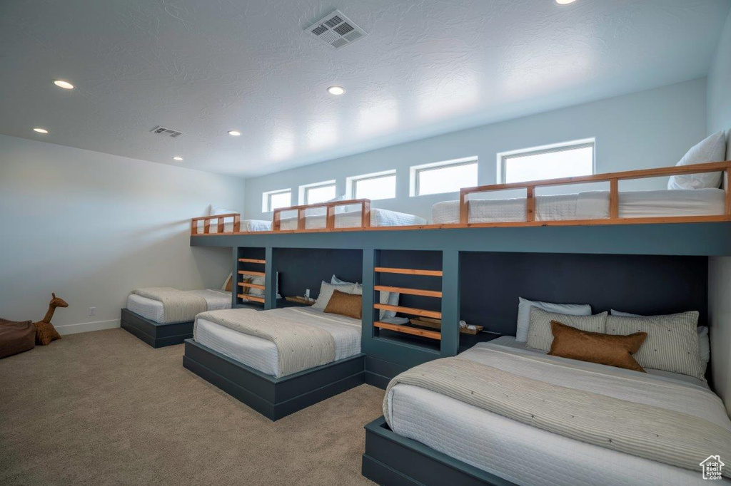 Carpeted bedroom with recessed lighting and baseboards