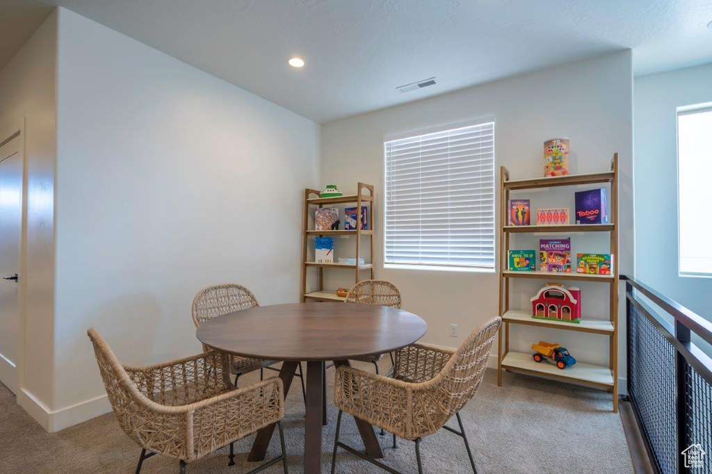 Carpeted dining space with plenty of natural light, baseboards, and recessed lighting