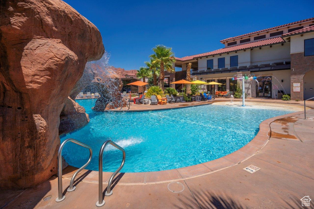 Community pool with a patio
