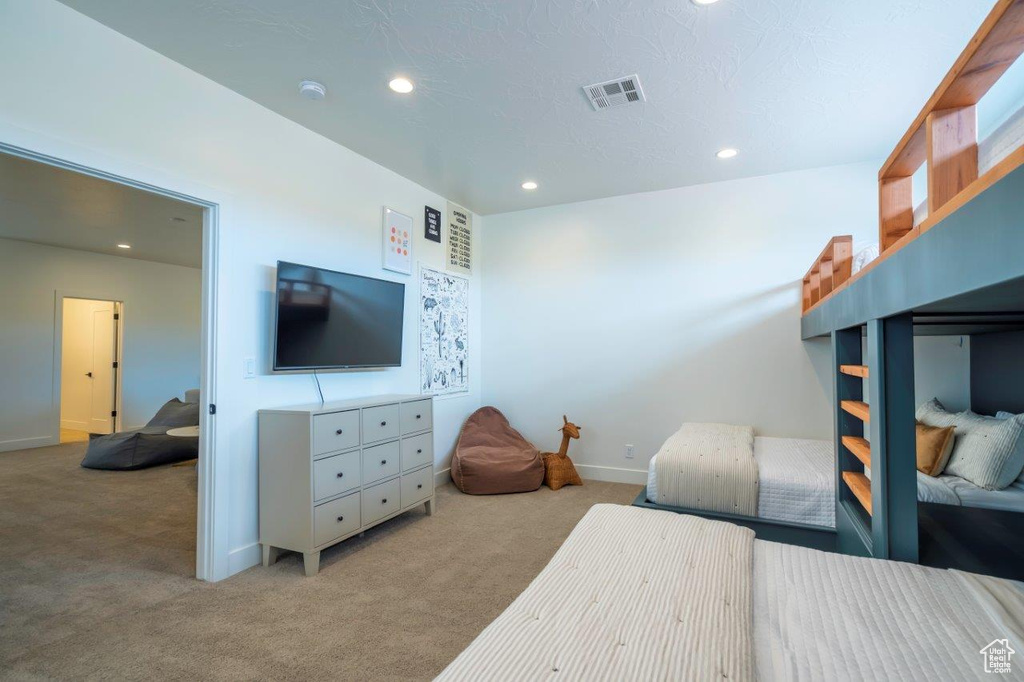 Carpeted bedroom with recessed lighting and baseboards