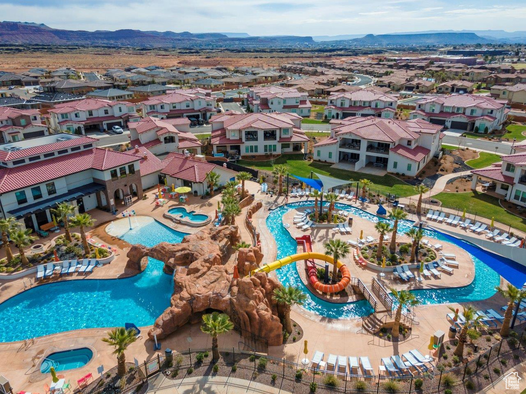 Aerial view of residential area with a pool and mountains