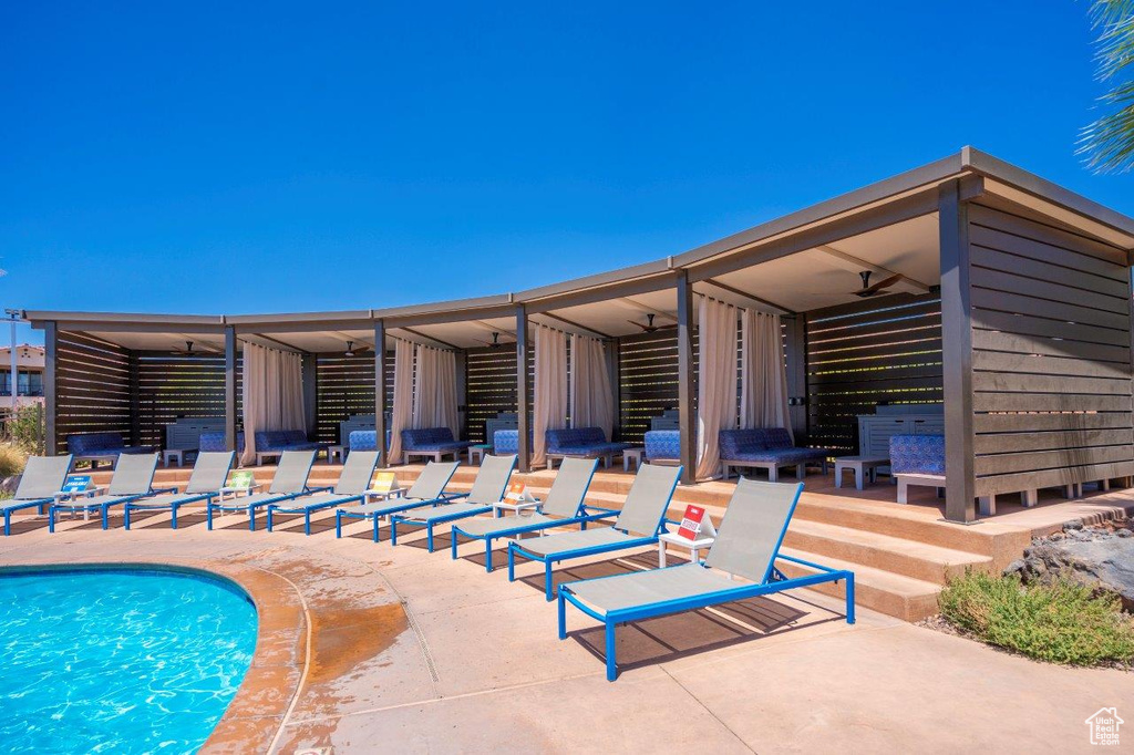 Outdoor pool with ceiling fan and a patio